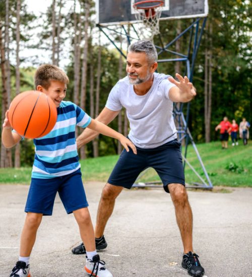 Multi-generations Playing Basketball Outdoors